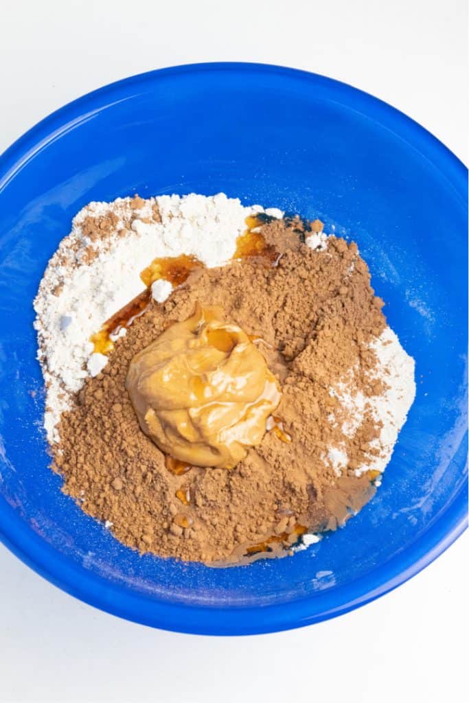 dry ingredients in blue mixing bowl for vegan chocolate recipe