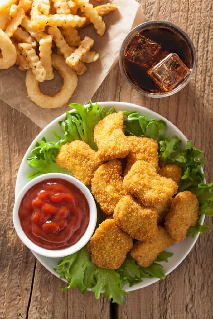fast food vegan nuggets with ketchup, french fries, cola