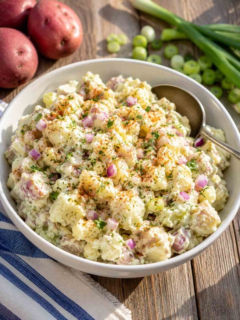 homemade vegan potato salad in a white bowl.