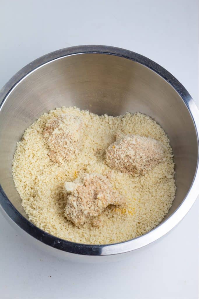 stainless bowl with bread crumbs and cauliflower chunks