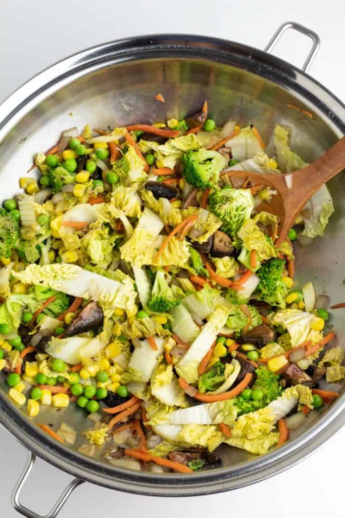 silver wok with stir fried vegetables