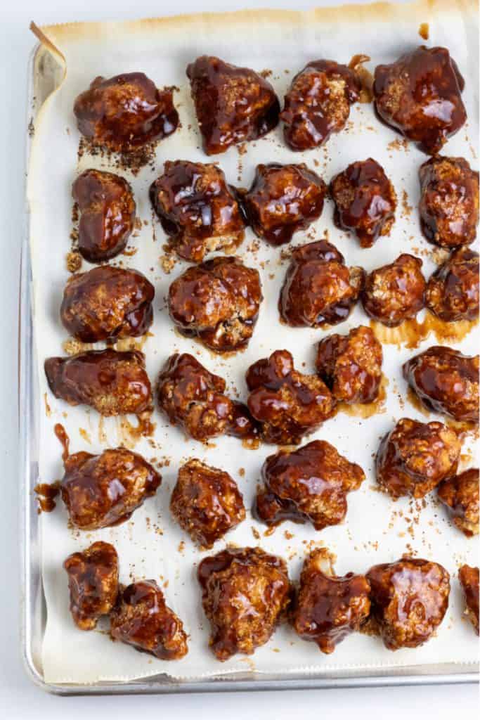 bbq cauliflower wings on baking pan with parchment paper
