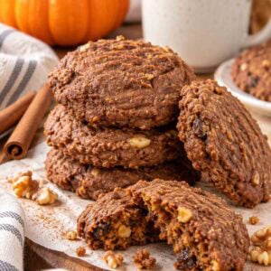 dairy-free pumpkin cookies on a plate with coffee and pumpkin in background.