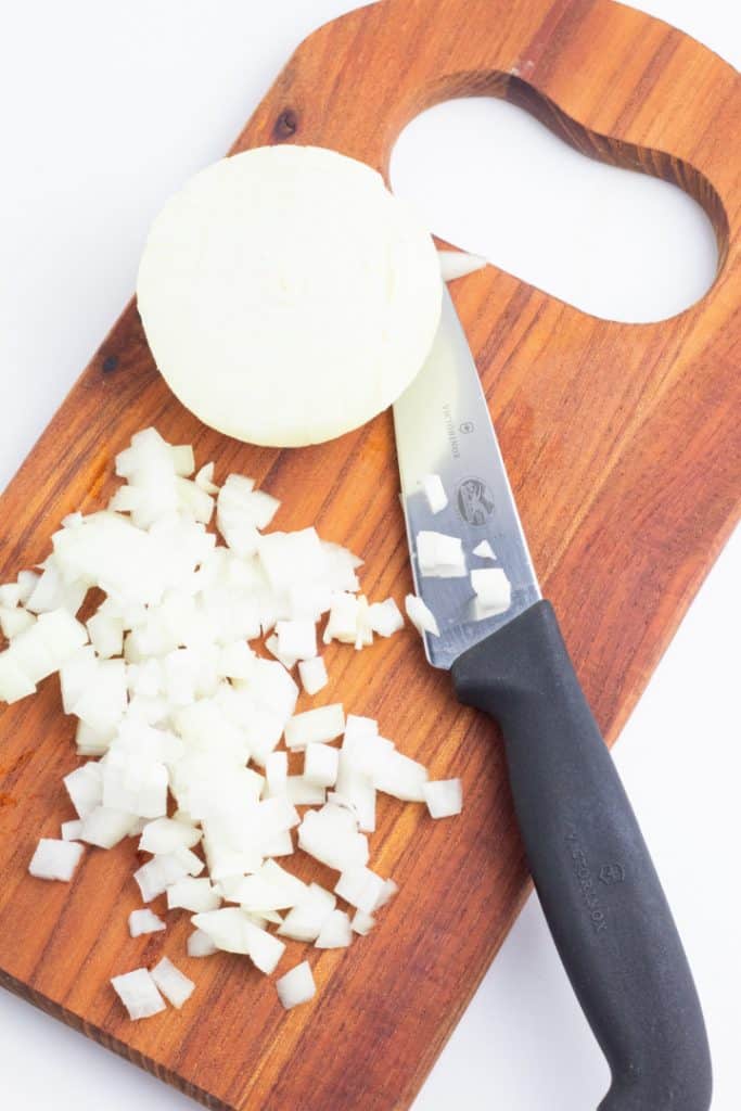 onions diced with knife on cutting board