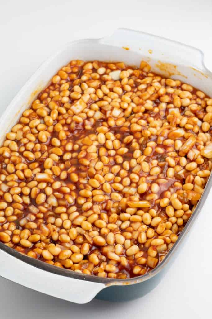 casserole dish with uncooked baked beans