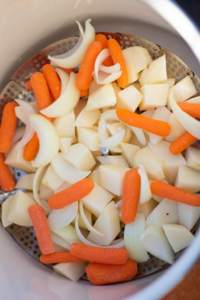 steamed potatoes and carrots in steamer basket
