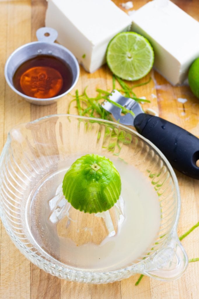 lime on glass juicer with other ingredients in background