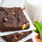 black bean brownies sliced and stacked on parchment paper