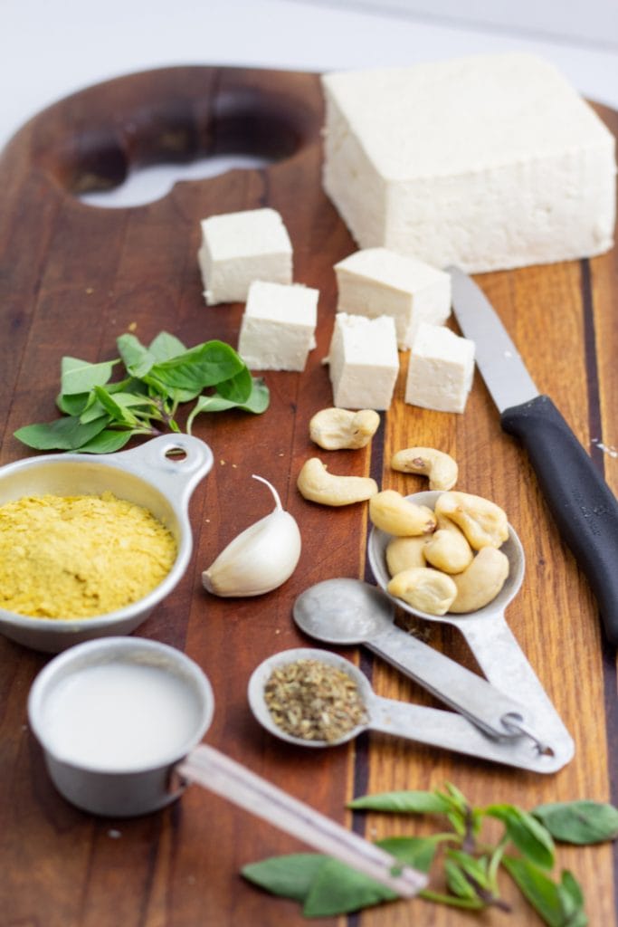 vegan ricotta ingredients on cutting board tofu, cashews, garlic, spices