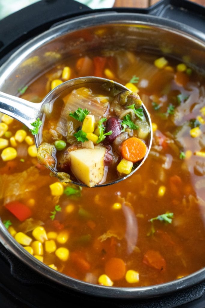 ladle of vegetable soup over instant pot