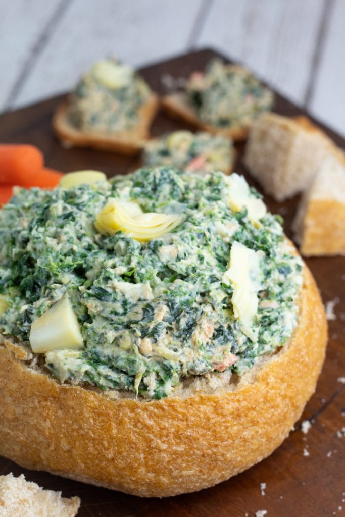 sour dough bread bowl filled with spinach dip