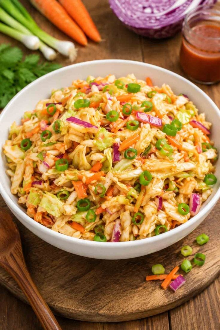 red slaw in a white bowl on rustic table.