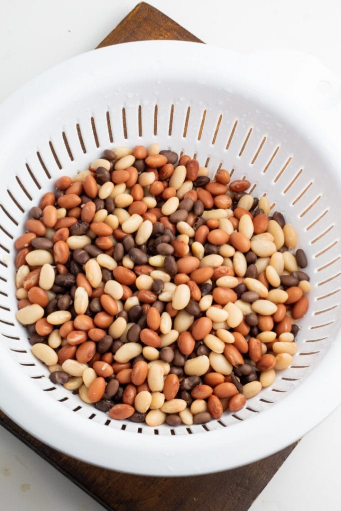 mixed beans in white colander
