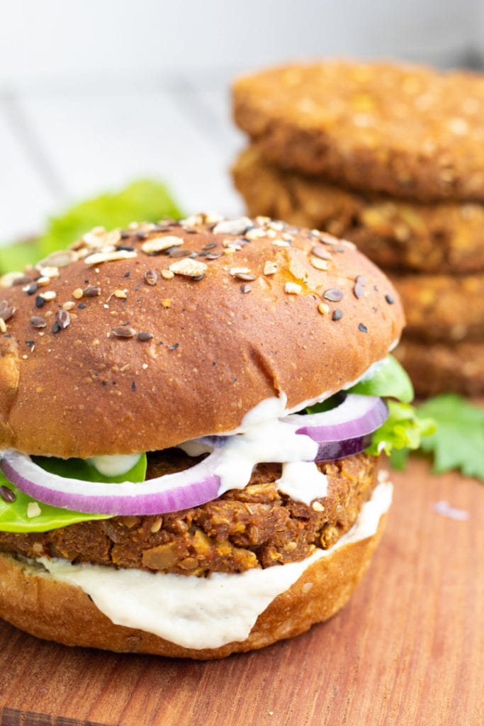 close up of a chickpea burger with chickpea patties in background