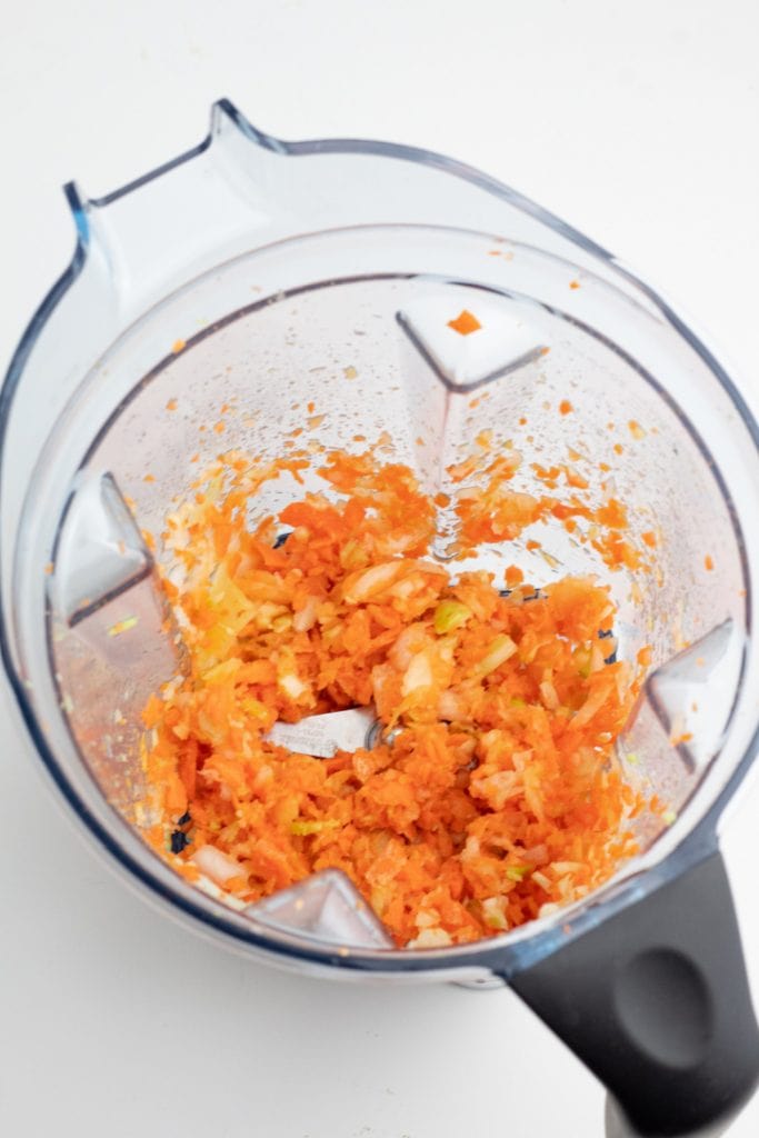 vitamix with chopped carrots, onions, celery