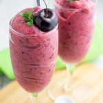 2 fancy classes filled with nice cream and topped with a cherry