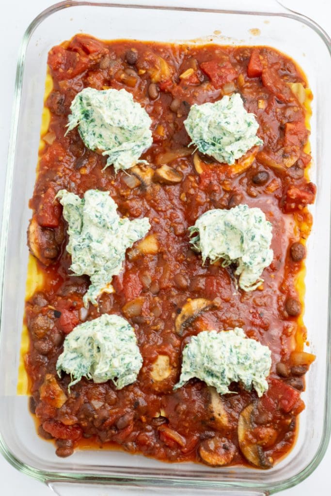 lasagna in casserole dish with vegan ricotta