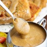 vegan gravy being spooned out of silver gravy boat