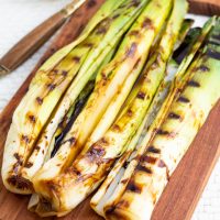 leeks with grill lines on wooden board