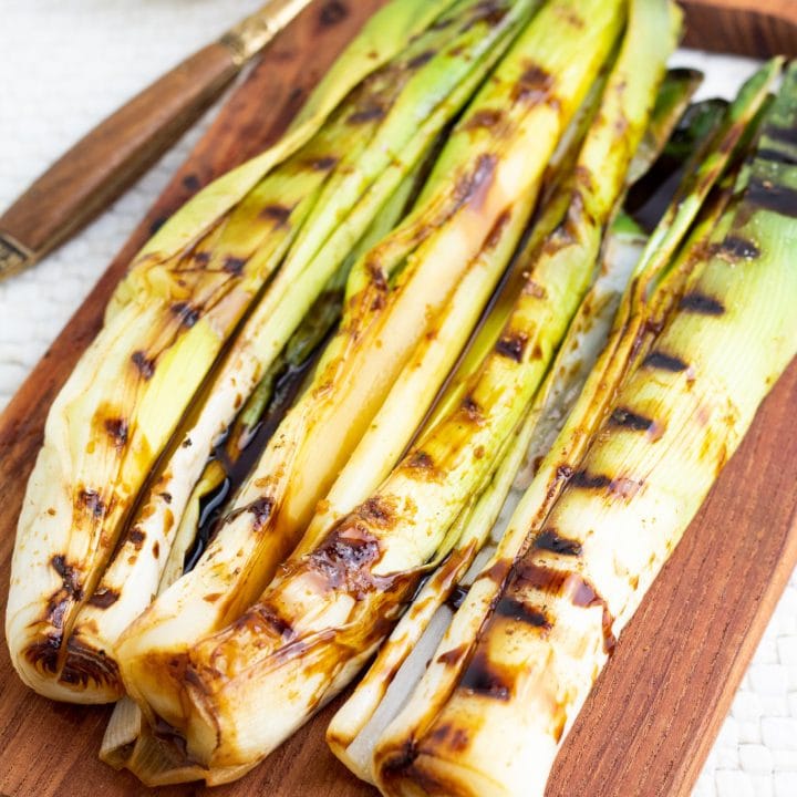 leeks with grill lines on wooden board