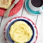 bright colorful bowl and saucer filled with plant based butter, toast and coffee in background