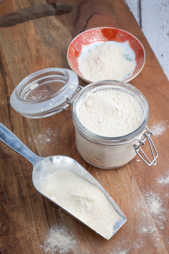 silver scoop of homemade powdered sugar with mason jar