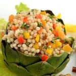 colorful artichoke bowl filled with couscous salad