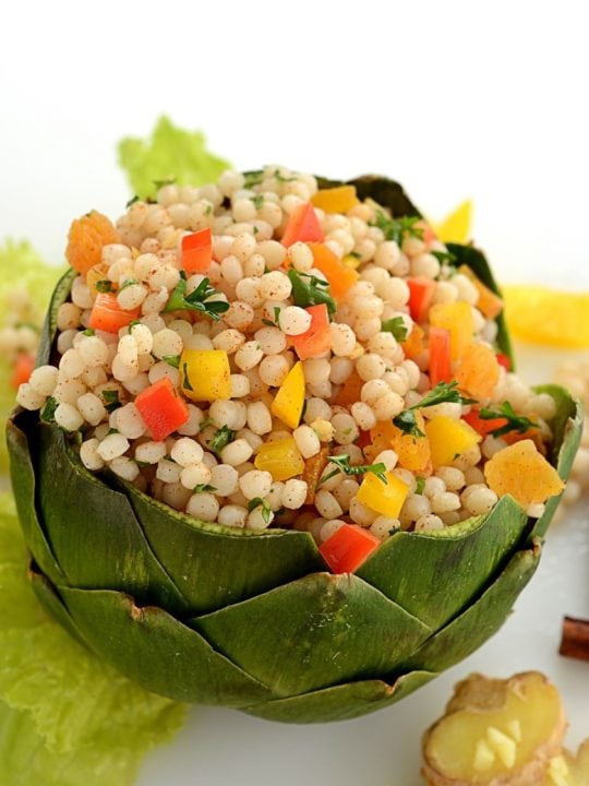 colorful artichoke bowl filled with couscous salad