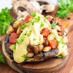 large stuffed mushroom cap on cutting board