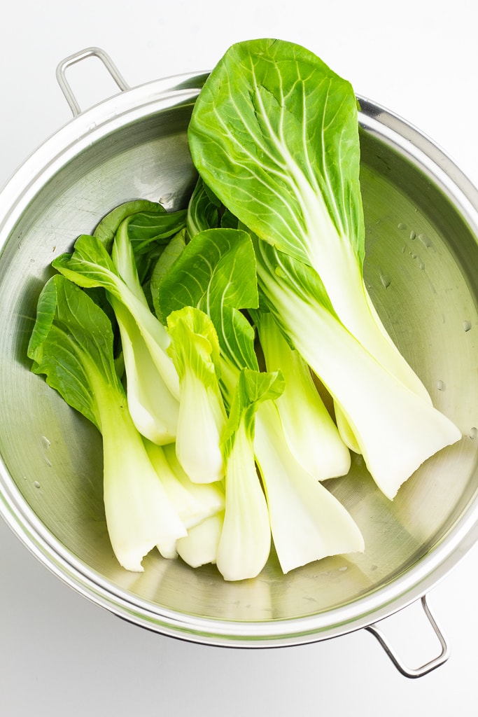 bok choy leaves in stainless wok