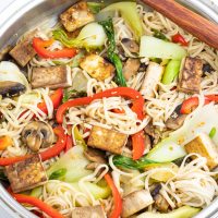 tofu veggie stir fry in wok with wooden spoon