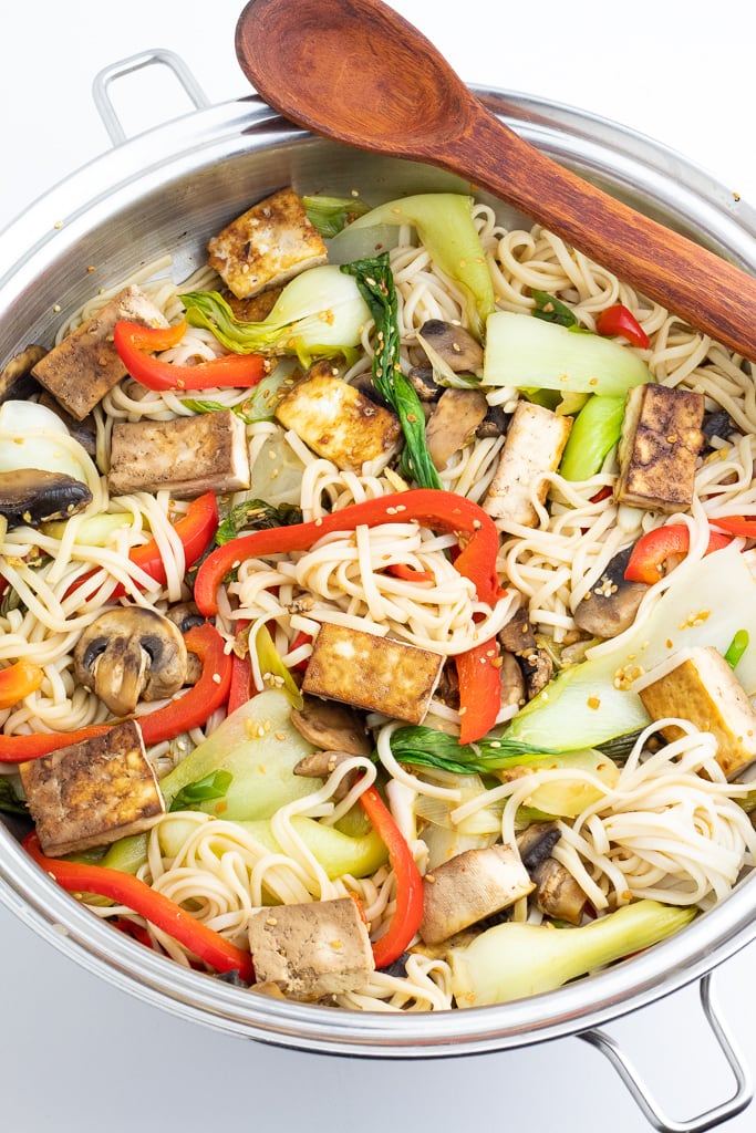 tofu veggie stir fry in wok with wooden spoon