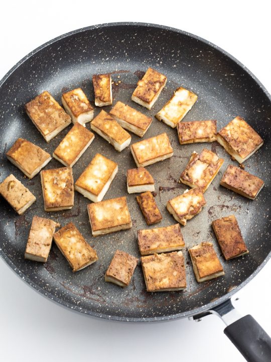 non stick pan with browned tofu chunks