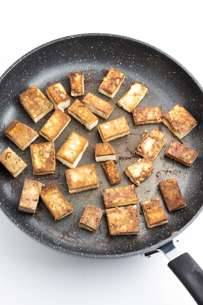 non stick pan with browned tofu chunks