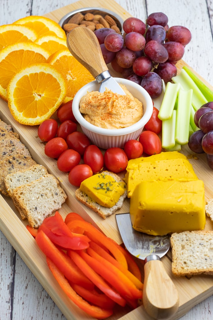 Vegan Charcuterie Board with hummus, vegan cheese, and veggies