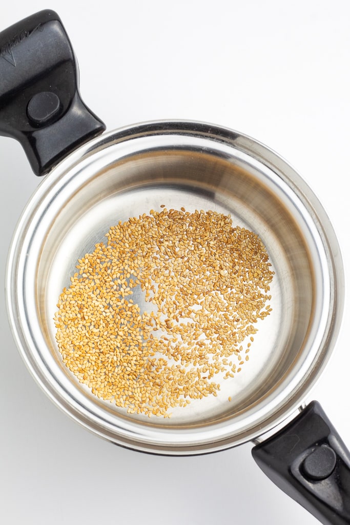 stainless saucepan with toasted sesame seeds
