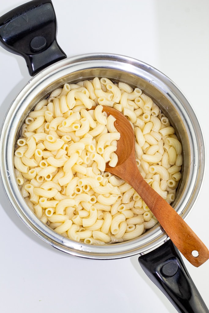 elbow macaroni cooking in stainless pot