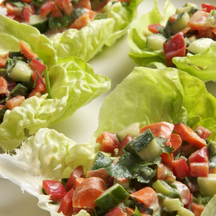 lettuce wraps stuffed with veggies on white platter