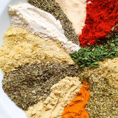 herbs and spices on white plate to make seasoning blend