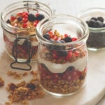 instant pot yogurt dessert with berries on white background