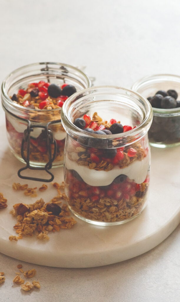 instant pot yogurt dessert with berries on white background