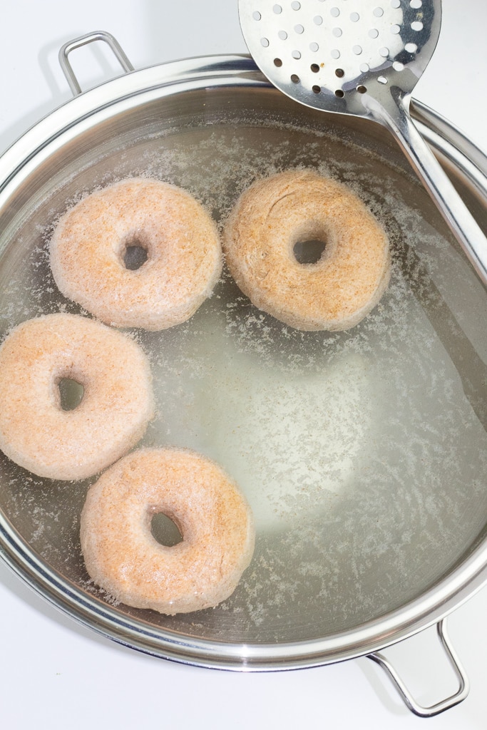 stainless pot with bagels in water