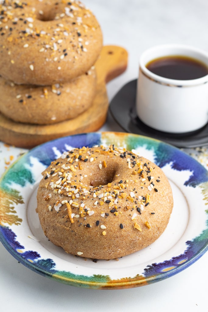decorative plate with bagel and cup of coffee