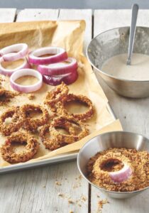 baked onion rings on baking sheet with parchment paper