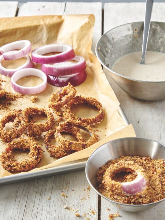 baked onion rings on baking sheet with parchment paper