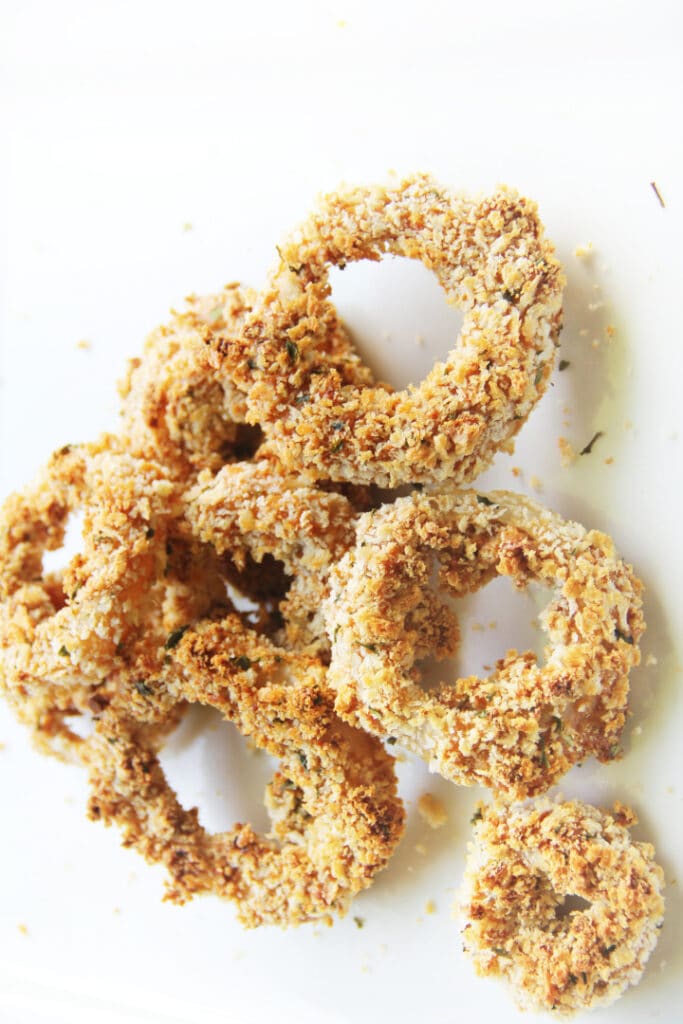 baked onion rings on white background