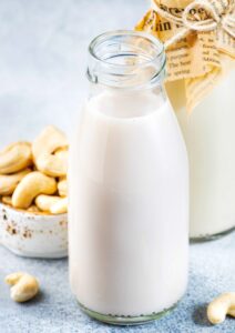 Vegan Cashew nut milk in bottles, closeup, white background.