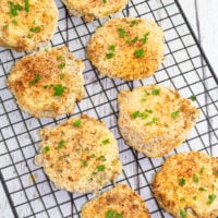 cooked air fried green tomatoes on black cooling rack