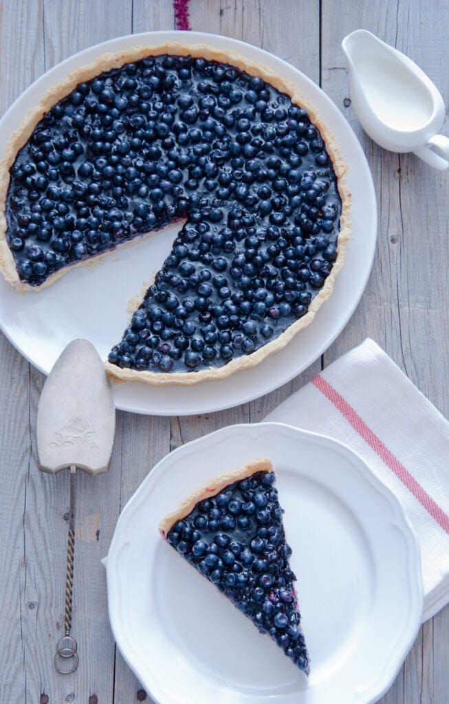 Blueberry pie with one slice missing