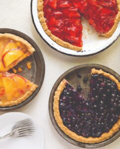 3 fruit pies, blueberry, strawberry, peach